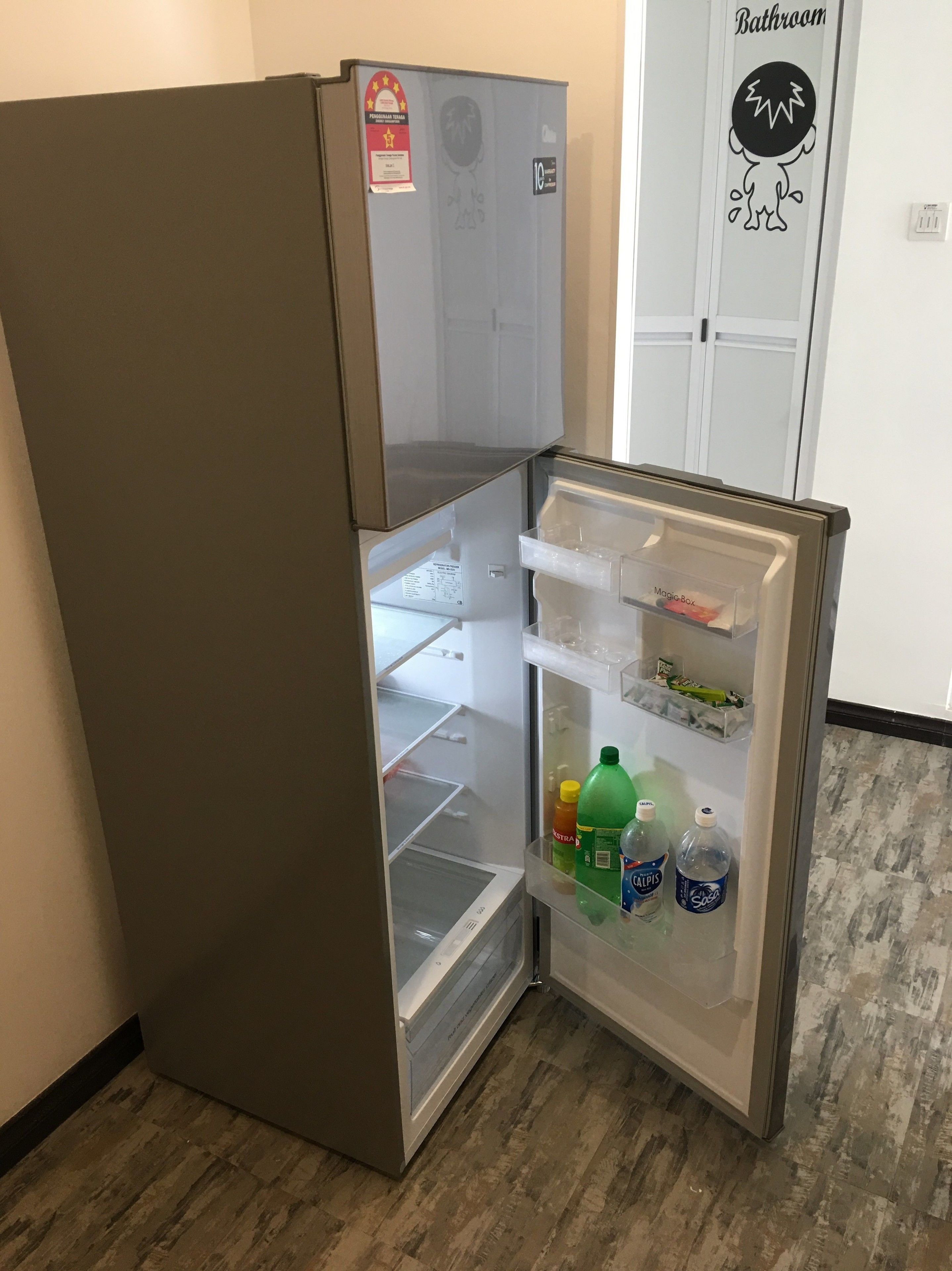 A compact refrigerator with a freezer compartment, a water dispenser, and a small refrigerator section.