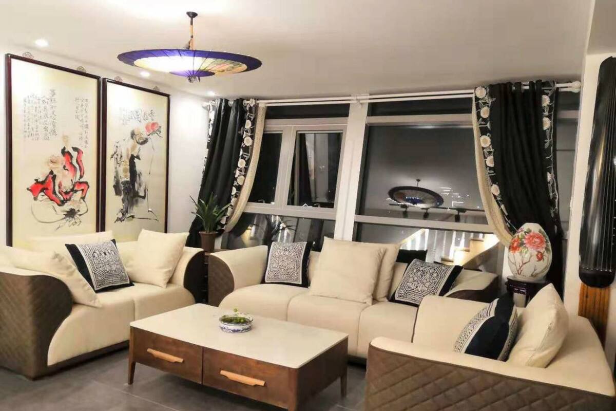 A living room with a sofa set, a coffee table, and decorative items.
