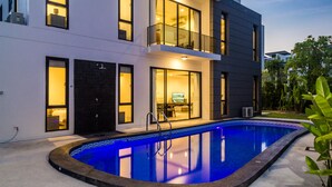 A modern two-story building with a swimming pool.