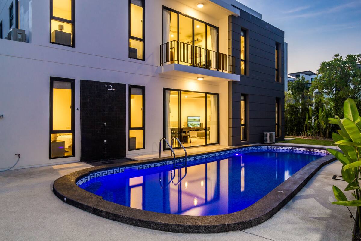 A modern two-story building with a swimming pool.