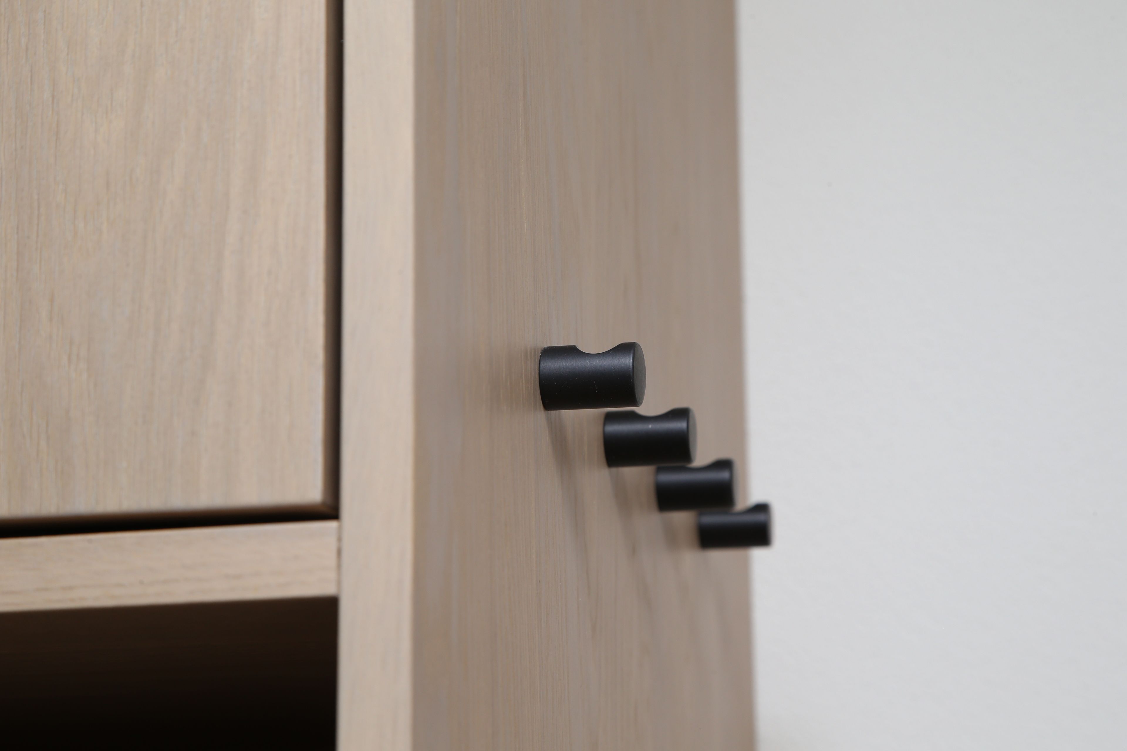 Een houten deur met een zwarte deurklink.