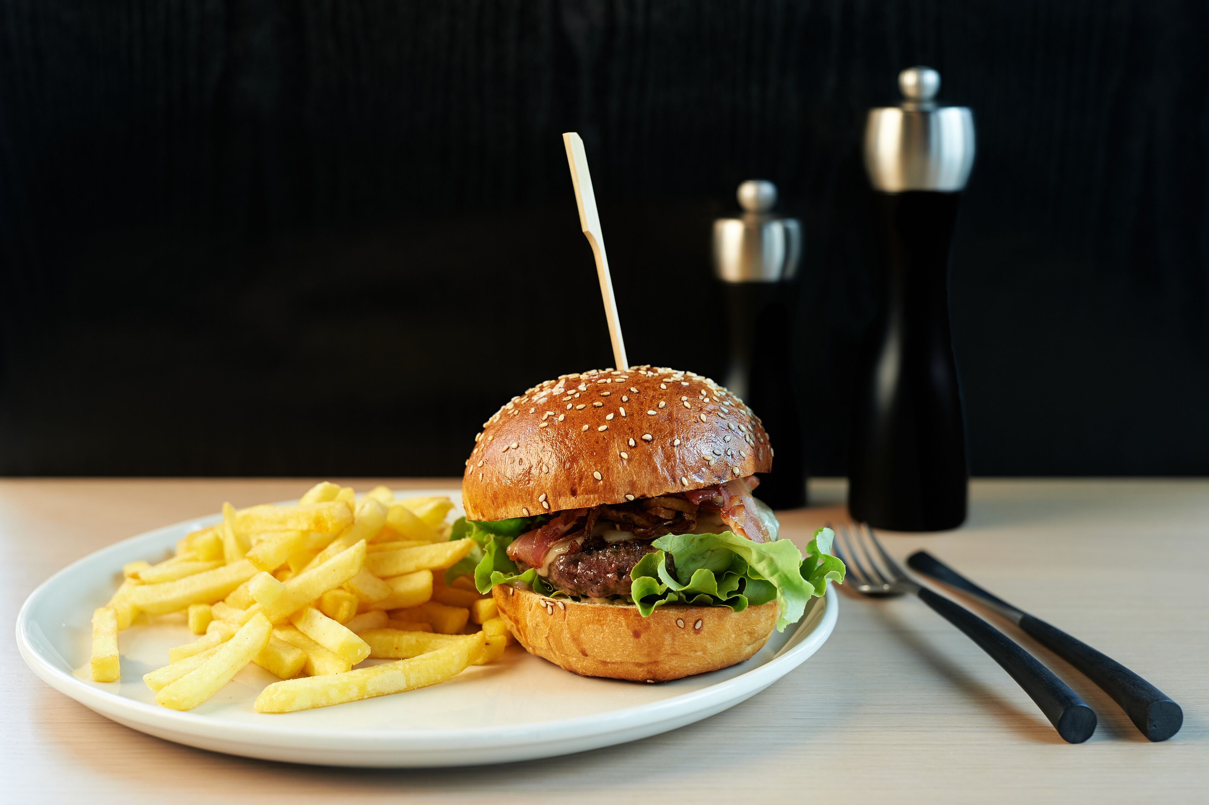 Un plato con una hamburguesa y papas fritas.