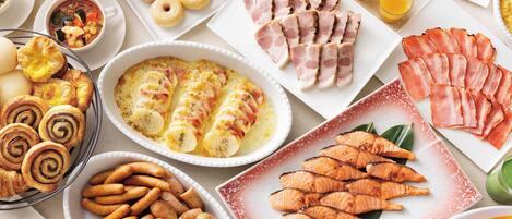 A variety of food items including pastries, smoked salmon, and grilled chicken.