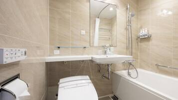 Un baño moderno con inodoro, lavamanos y bañera.