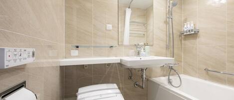 A modern bathroom with a toilet, sink, and bathtub.