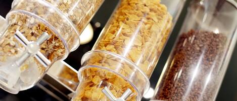 A food display with various types of cereal in transparent containers.