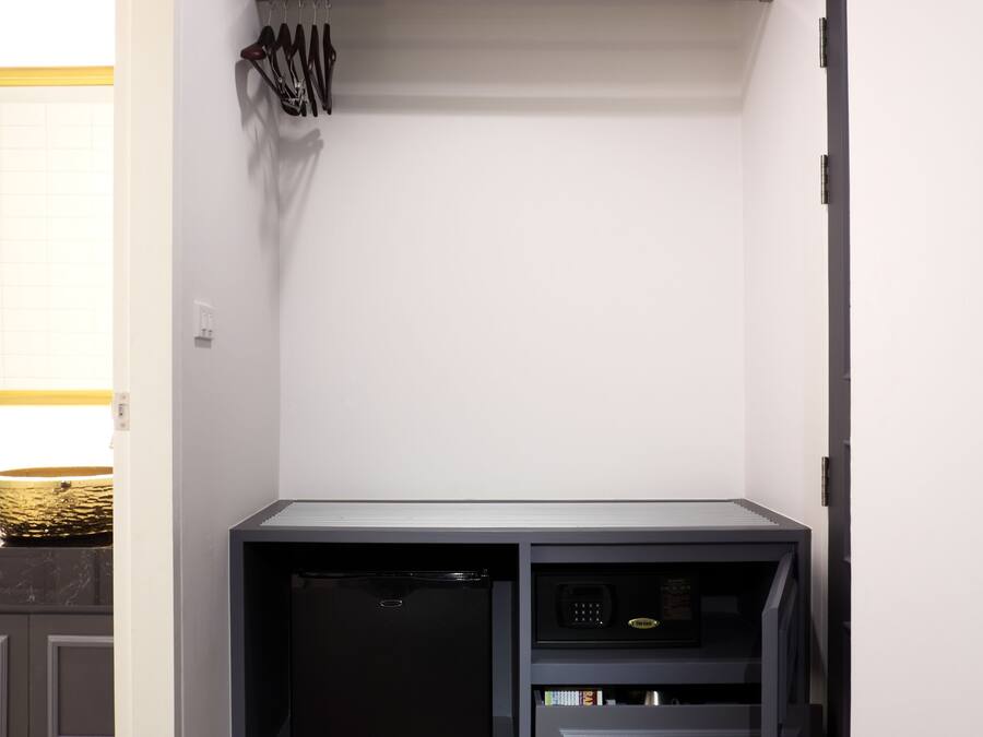 A compact kitchen with a built-in dishwasher, a microwave, and a small countertop.