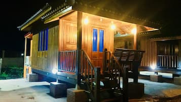 Cozy cabin-style building with a front porch and stairs leading to the entrance.