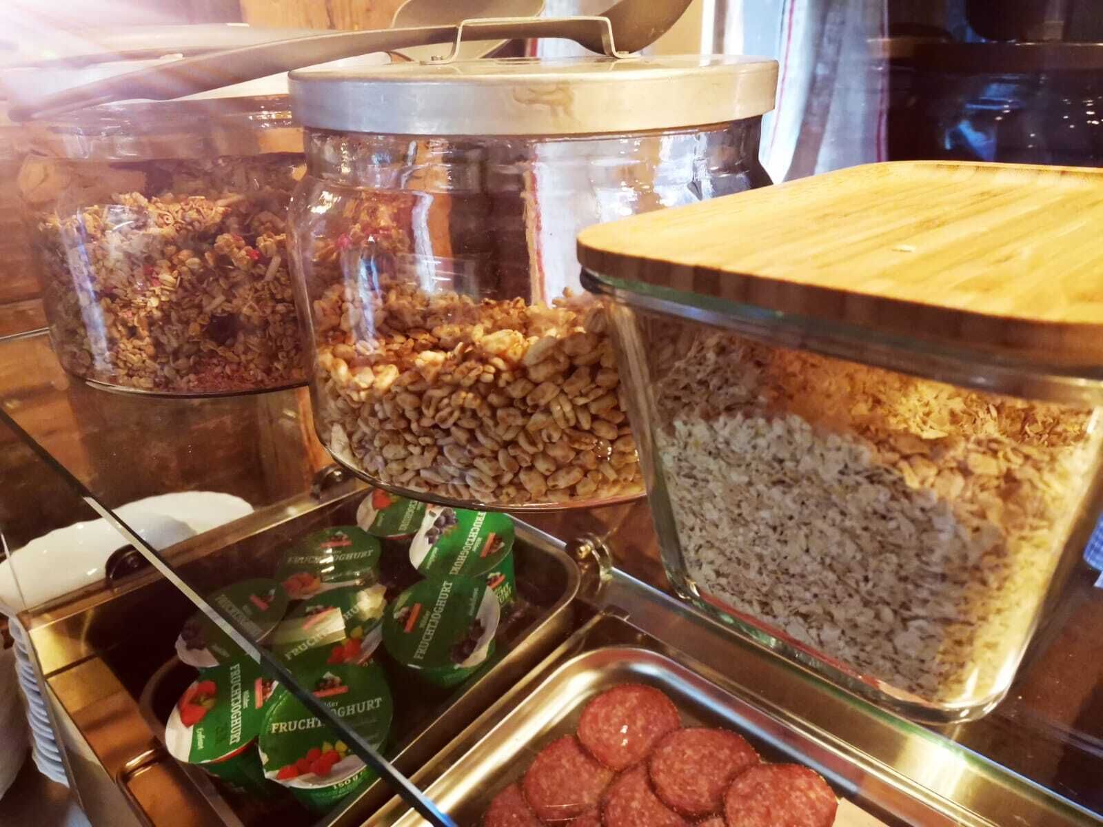 A buffet with various food items including nuts, dried fruits, and packaged snacks.