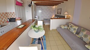 A compact living space with a kitchen, dining area, and a sofa. - Tango Studios (Corfu)