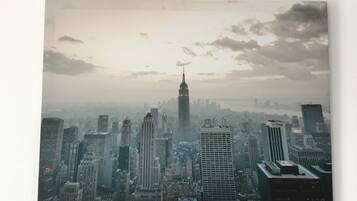 A cityscape with a prominent skyscraper in the center, surrounded by other high-rise buildings.
