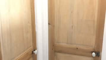 A wooden door with a white handle and a keyhole.