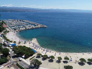 A coastal area with a marina, beach, and clear blue sea. - Designed Apartment with Swimming Pool (Opatija)