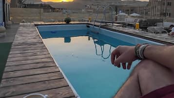 Outdoor pool, open 9:00 AM to 6:00 PM, lifeguards on site