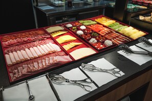 A buffet with various food items and utensils. - Hotel Jarun (Zagreb)