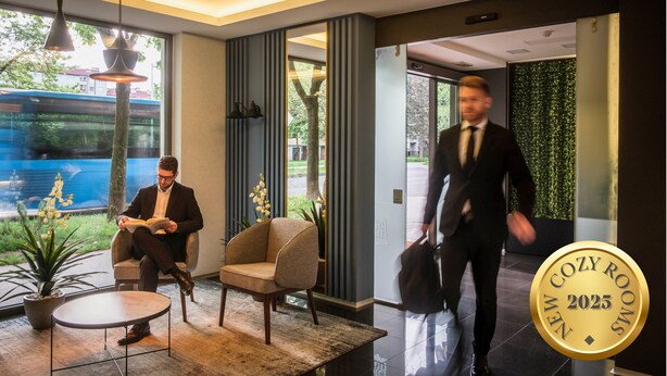 A modern lobby with a seating area, a large window, and a decorative plant. - Hotel Jarun (Zagreb)