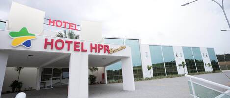 A modern hotel entrance with a prominent sign reading 'HOTEL HPR.'