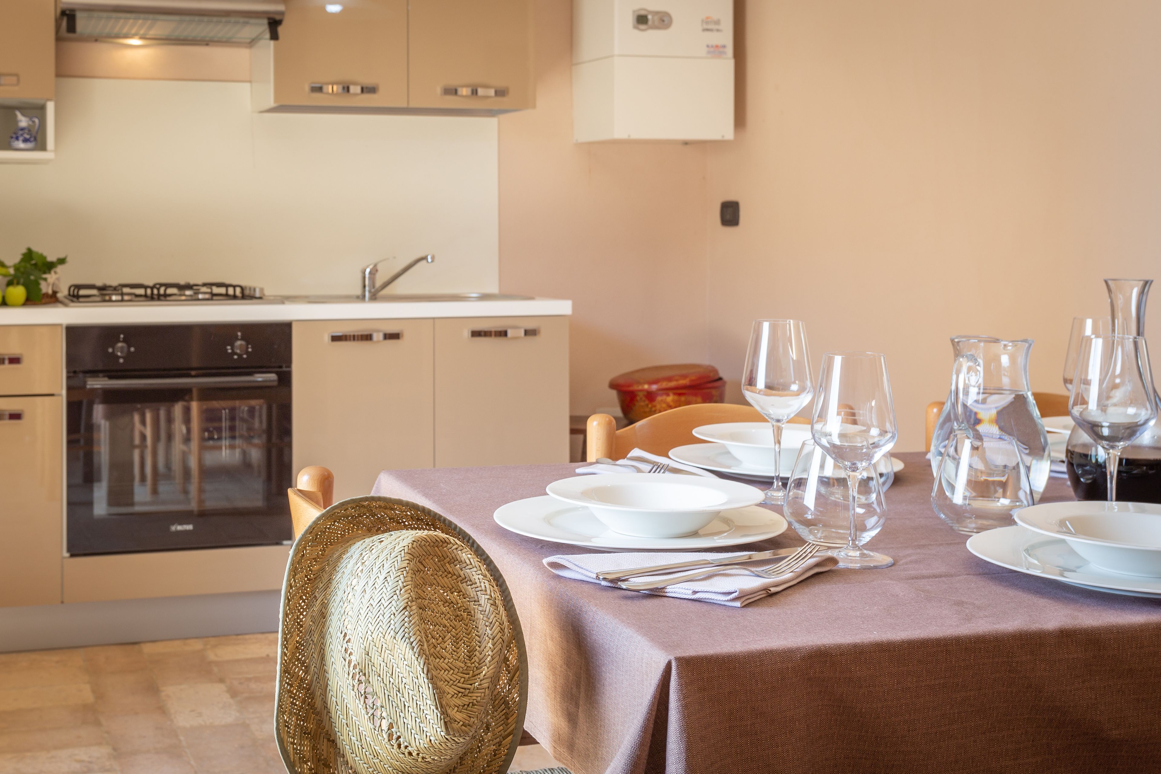 A dining area with a table set for four, including plates, glasses, and cutlery.