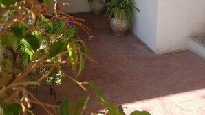 A covered entrance with potted plants and a door. - Art In B&B (Salerno)