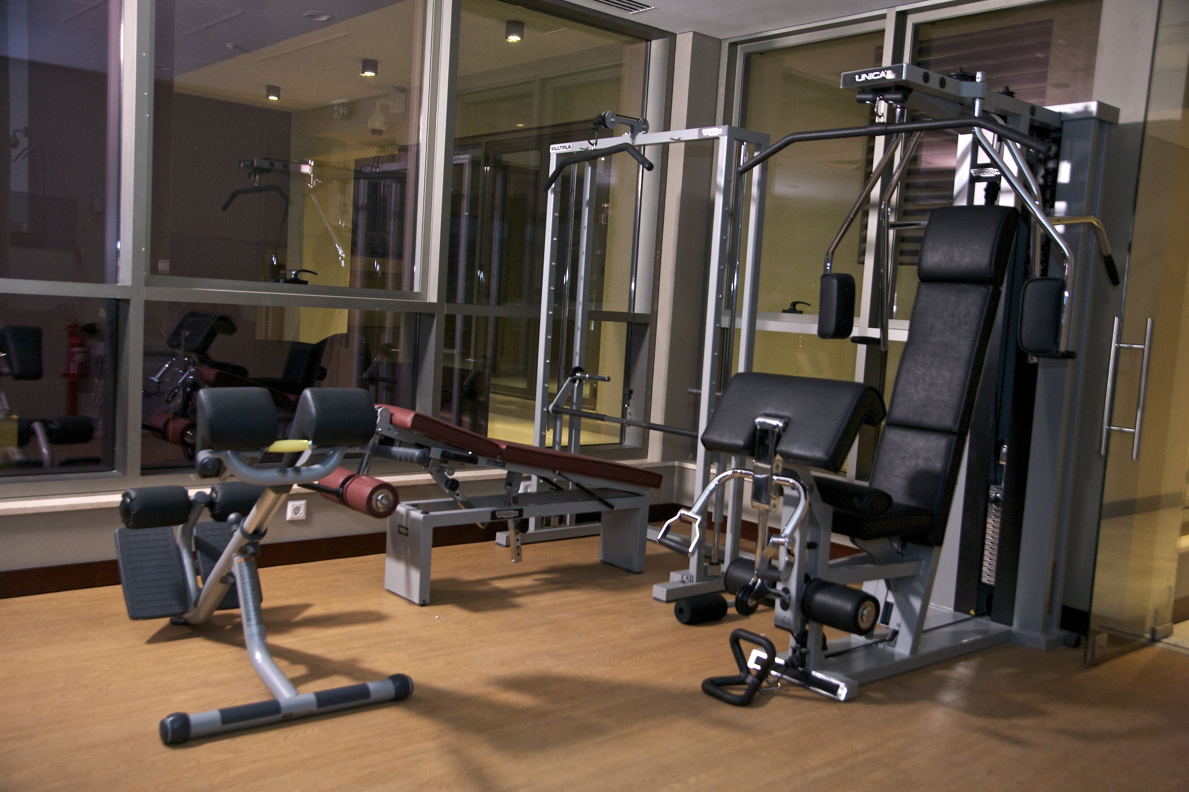 Una palestra con diverse macchine per esercizi, tra cui una leg press e una chest press.