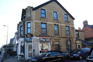 A two-story building with a shop on the ground floor named "Turkish Barber."
