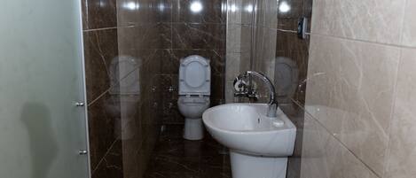 Ein Badezimmer mit Toilette, Bidet und Waschbecken.