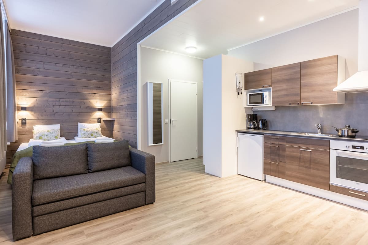 A modern kitchen with wooden cabinets, a microwave, and a dishwasher.