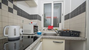A compact kitchen with a microwave, kettle, and sink. - Tequila apartments & rooms - Adults Only (Zadar)