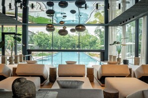 Indoor pool, outdoor pool, open 7:00 AM to 10:00 PM, pool umbrellas - Das Mühlbach - Thermal Retreat & Wellness Resort (Bad Fuessing)