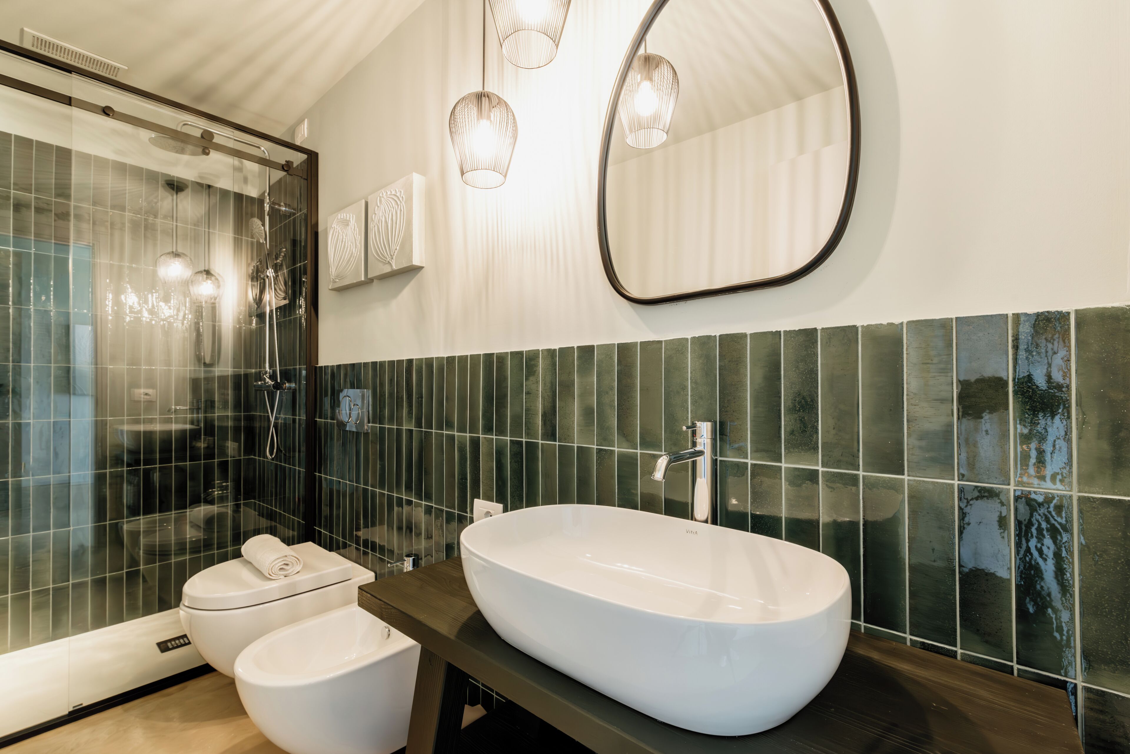 A modern bathroom with a freestanding bathtub, a glass-enclosed shower, and a large mirror.