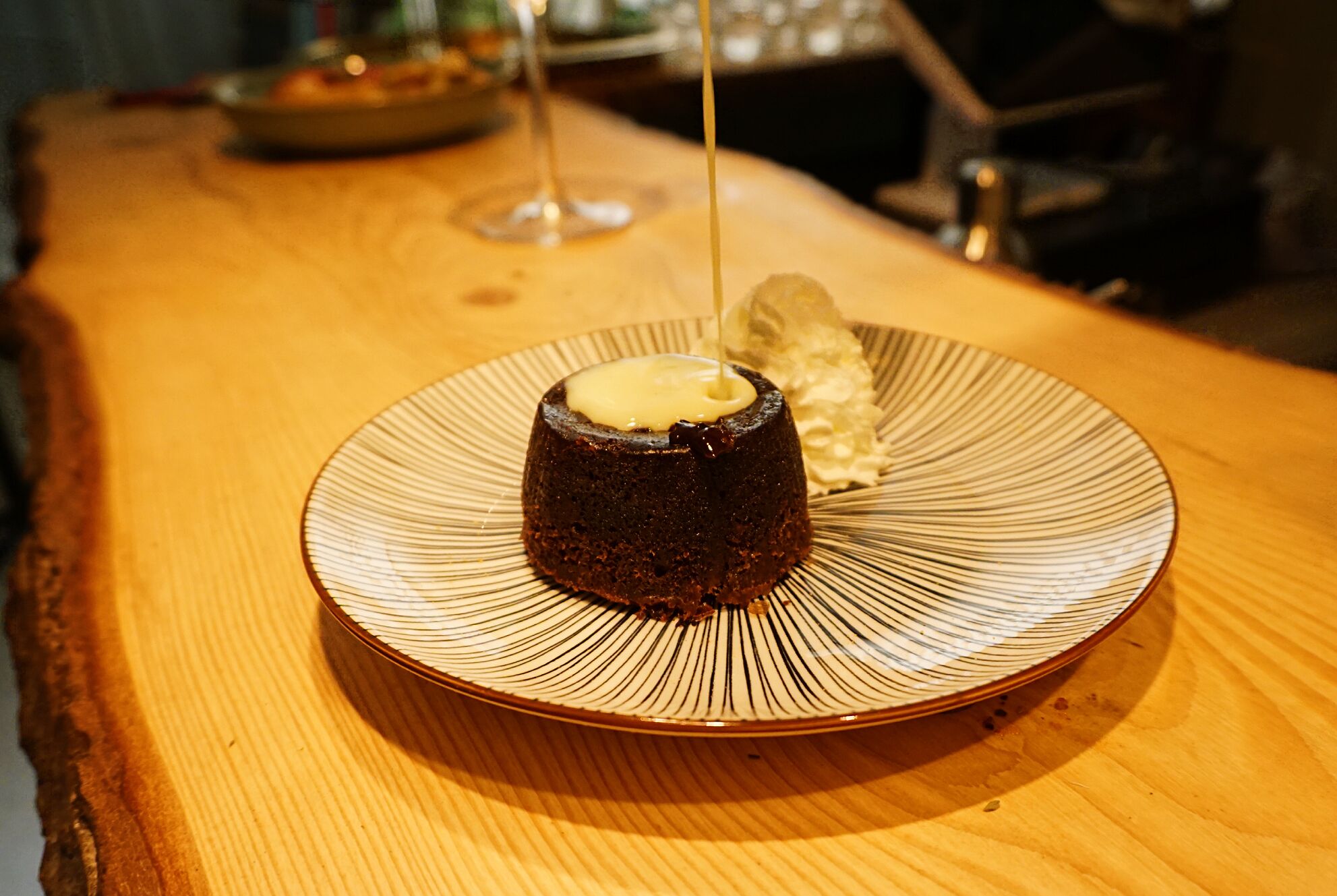 A dessert on a plate with a unique design, placed on a wooden table.