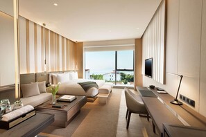 A modern hotel room with a large bed, a sofa, a desk, and a TV. - Joyze Hotel Xiamen Curio Collection by Hilton (Xiamen)