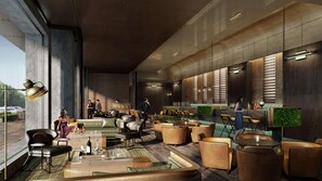A modern lounge area with leather seating, a bar with a green accent wall, and large windows providing natural light. - Joyze Hotel Xiamen Curio Collection by Hilton (Xiamen)