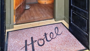 A hotel entrance with a wooden staircase leading to a room. - The Alyth Hotel (Blairgowrie)