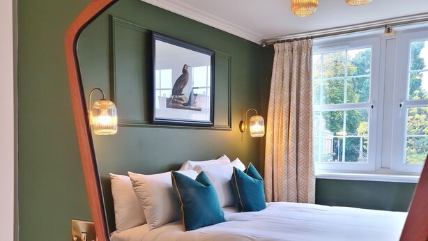 A bedroom with a bed, a framed picture, and a window with curtains. - The Alyth Hotel (Blairgowrie)