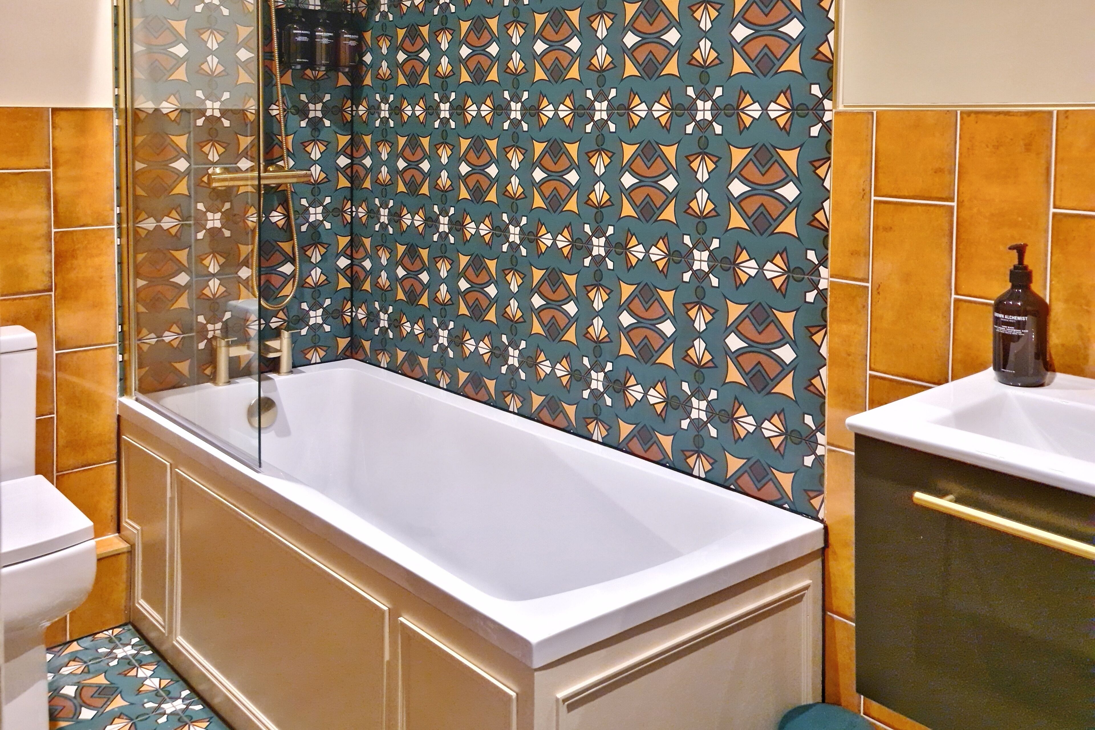A bathroom with a bathtub, a toilet, and a sink.