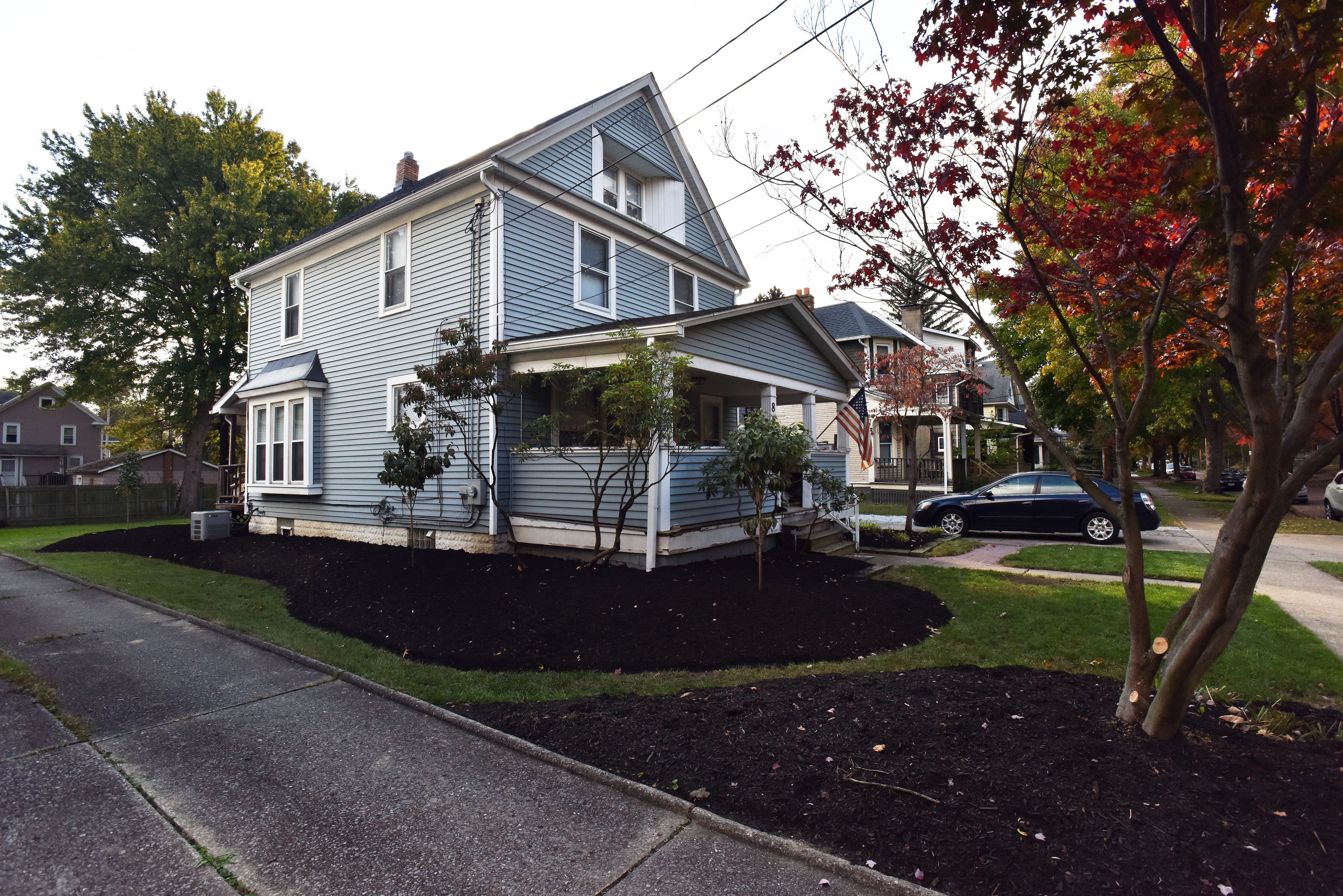 A two-story house with a front porch and a garage.