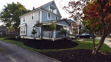 A two-story house with a front porch and a garage.