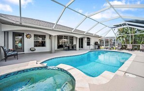 An indoor swimming pool with a glass ceiling, lounge chairs, and a sun decoration on the wall. - Scarlett - Fantastic Rental with 2 King Size Beds (Cape Coral)