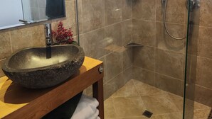 A modern bathroom with a stone sink, a glass shower enclosure, and a wooden vanity. -  Farm stay-Tranquil & quiet, relaxation country style (Sentry Hill)