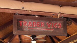 A kitchen area with a sign reading "TRADER VIC'S" and a ceiling fan. - Private Island, FL Keys Entire Island, Home, A/C, Boat, Dock, Beach, Bikes, WiFi (Marathon)