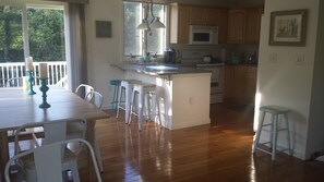 Enjoy cooking and dining in this well-equipped kitchen with a central island, microwave, and kettle.