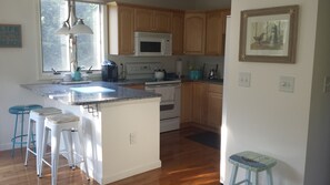 Kitchen with toaster oven, Kurig, Food Processor, Blender and more.