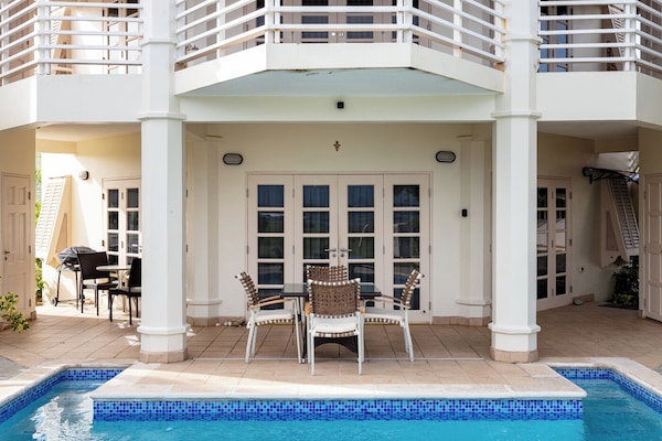 Luxurious poolside deck overlooking the ocean.