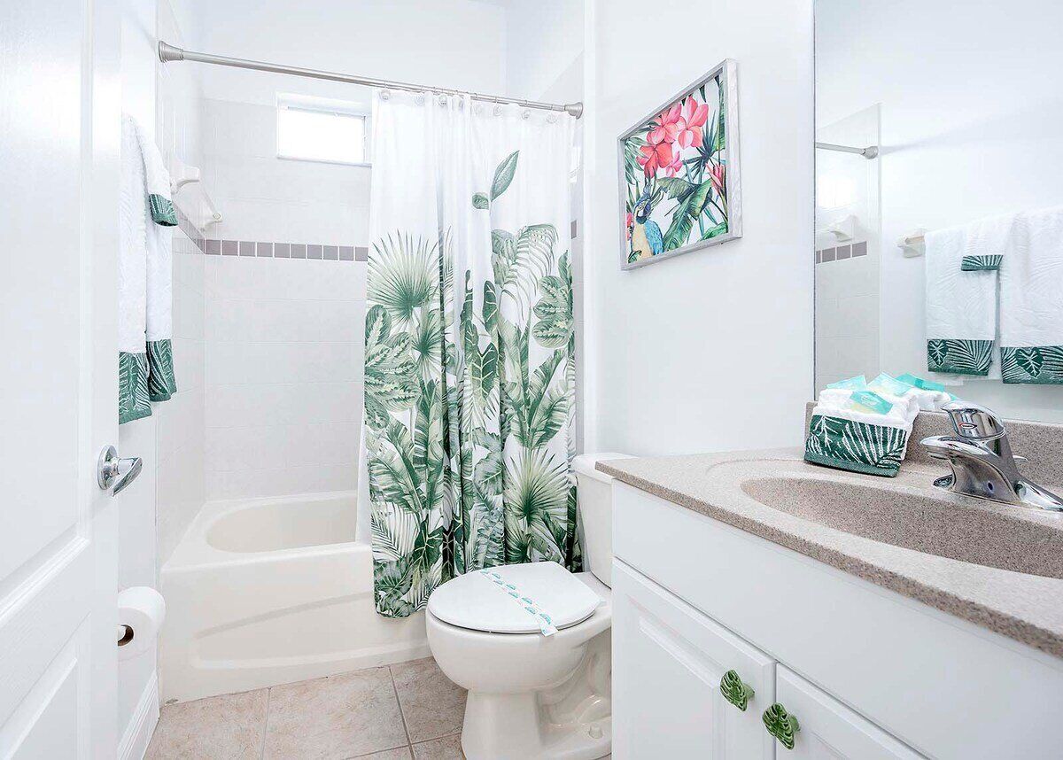 A bathroom with a bathtub, toilet, and sink.