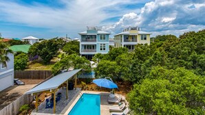 A two-story house with a swimming pool and a covered patio area. - Pool | Quiet Street | Steps to Beach | Chef's Kitchen | Large Yard (Destin)
