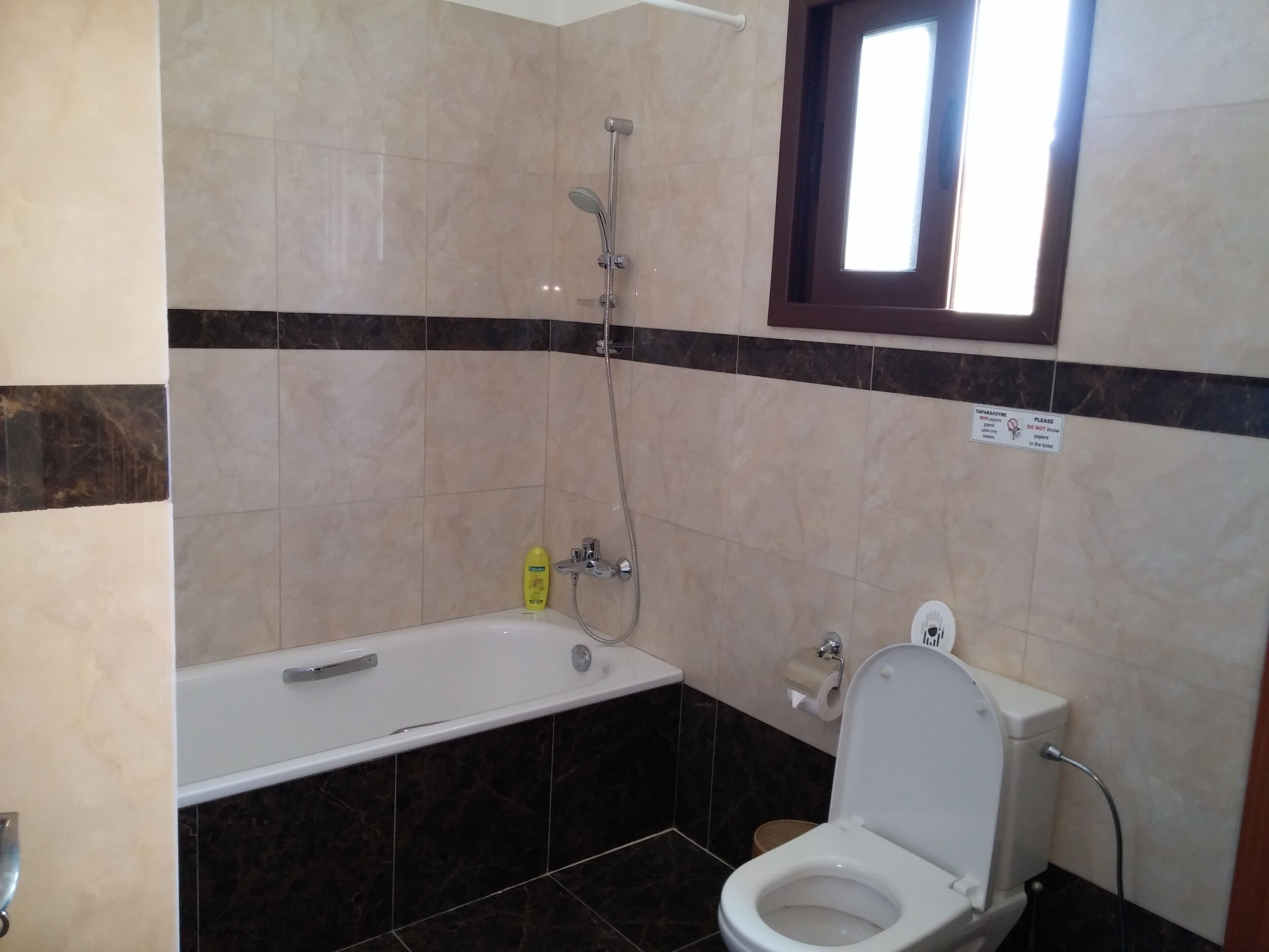 A bathroom with a bathtub, toilet, and shower.