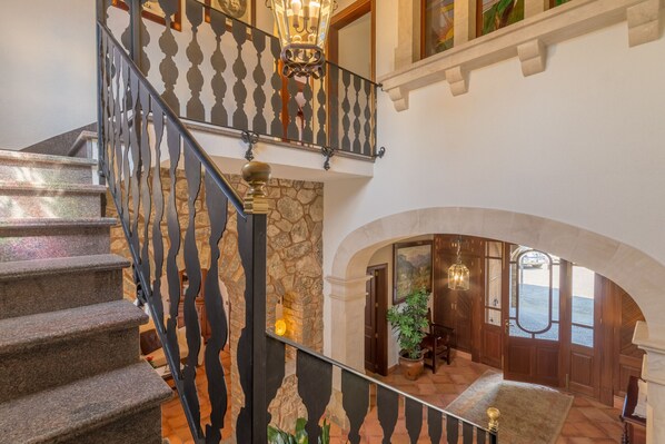 A grand staircase with ornate metal railings leading to an upper level.