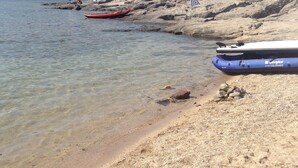 A beach with clear water, rocky shore, and boats. - Terrace with dreamy sunsets over the sea! ( CIN code IT111071C2000T8749) (Sant’Antioco)