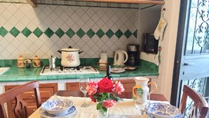 A dining table set with plates, a vase of flowers, and a pitcher.